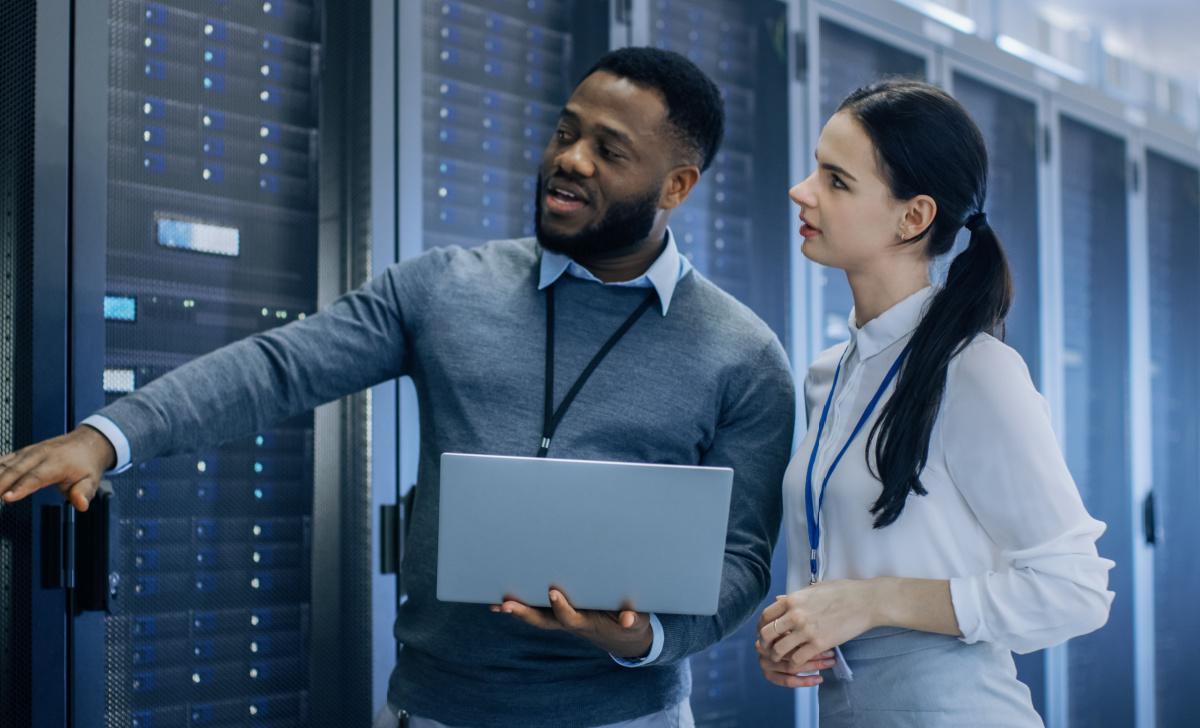 An IT professional explains how the data center works to a new employee