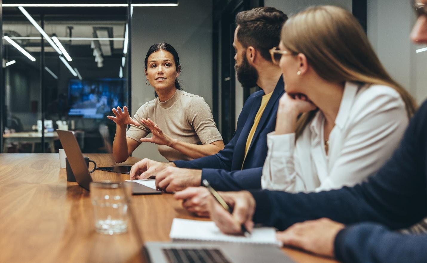 A businesswoman leading a meeting in a conference room