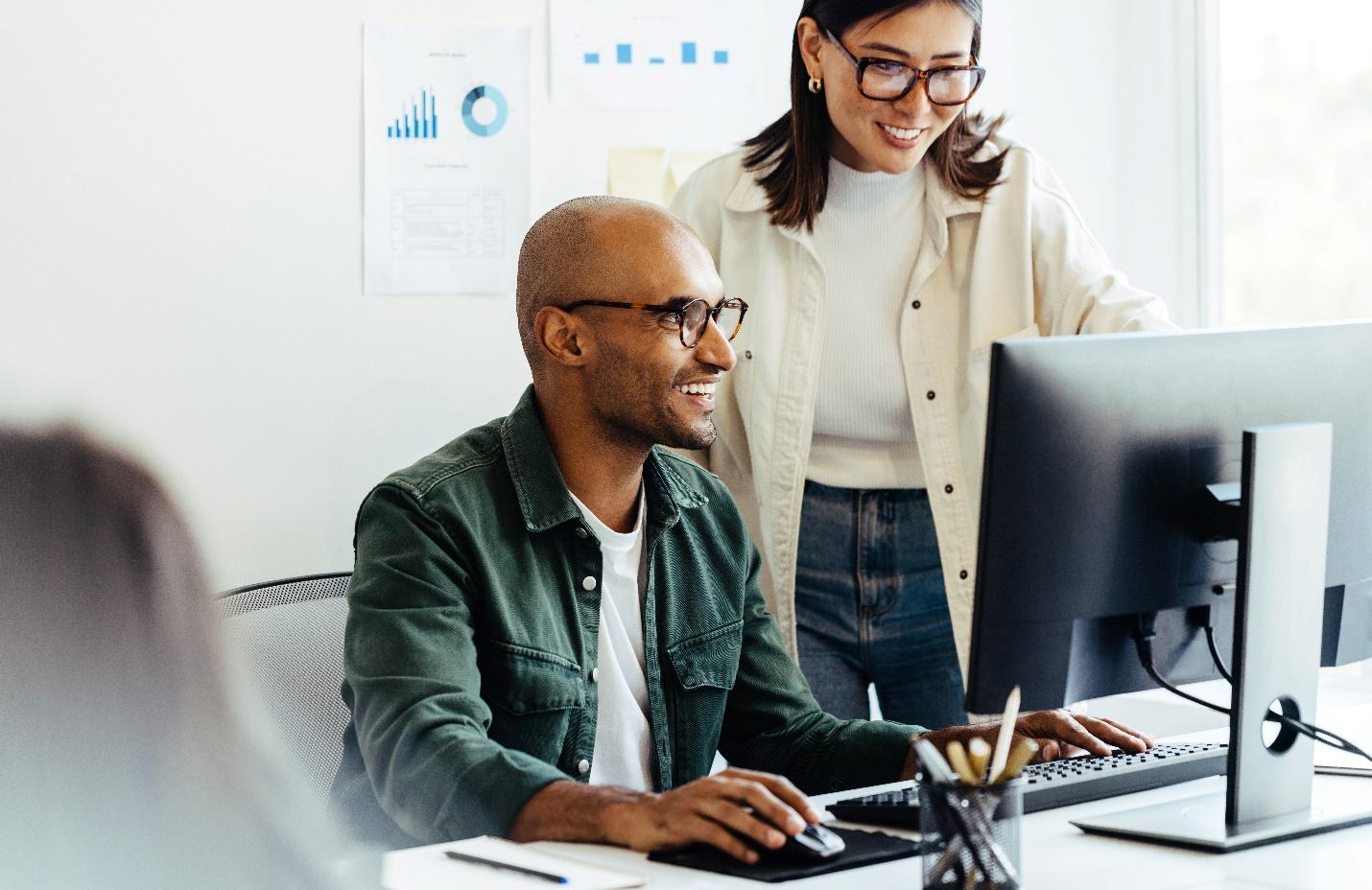 Two IT professionals working together in an office.