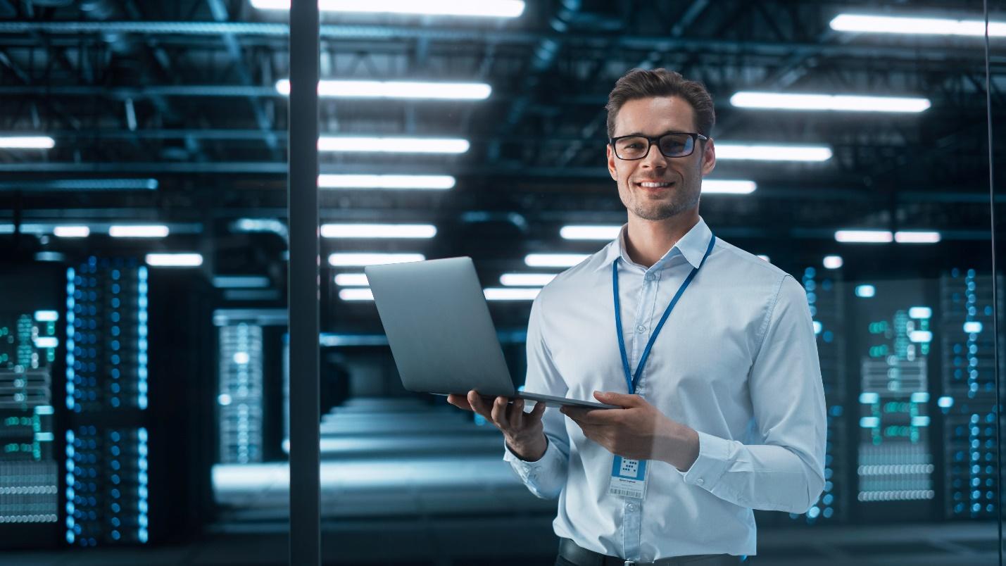 Young male IT professional working in a data center.