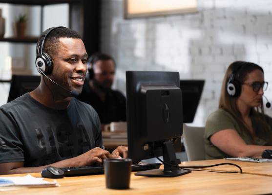 support technician typing on keyboard while speaking on headset